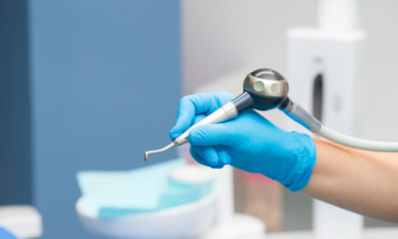 Hygienist doing airflow cleaning