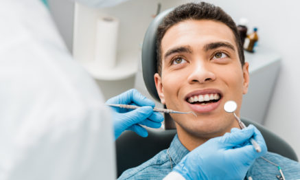Patient having a dental routine examination or check-up by dentist